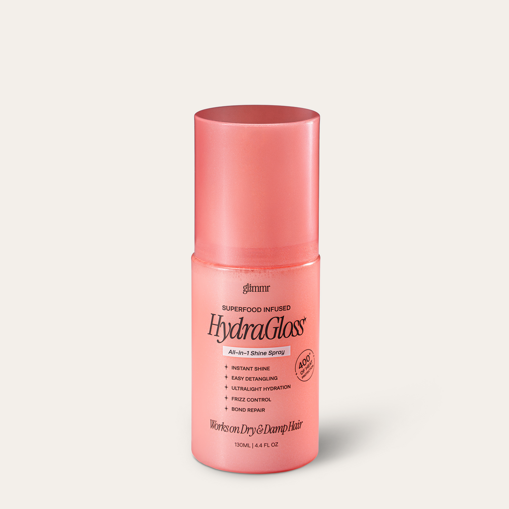 Pink bottle of HydraGloss hair product on a white background