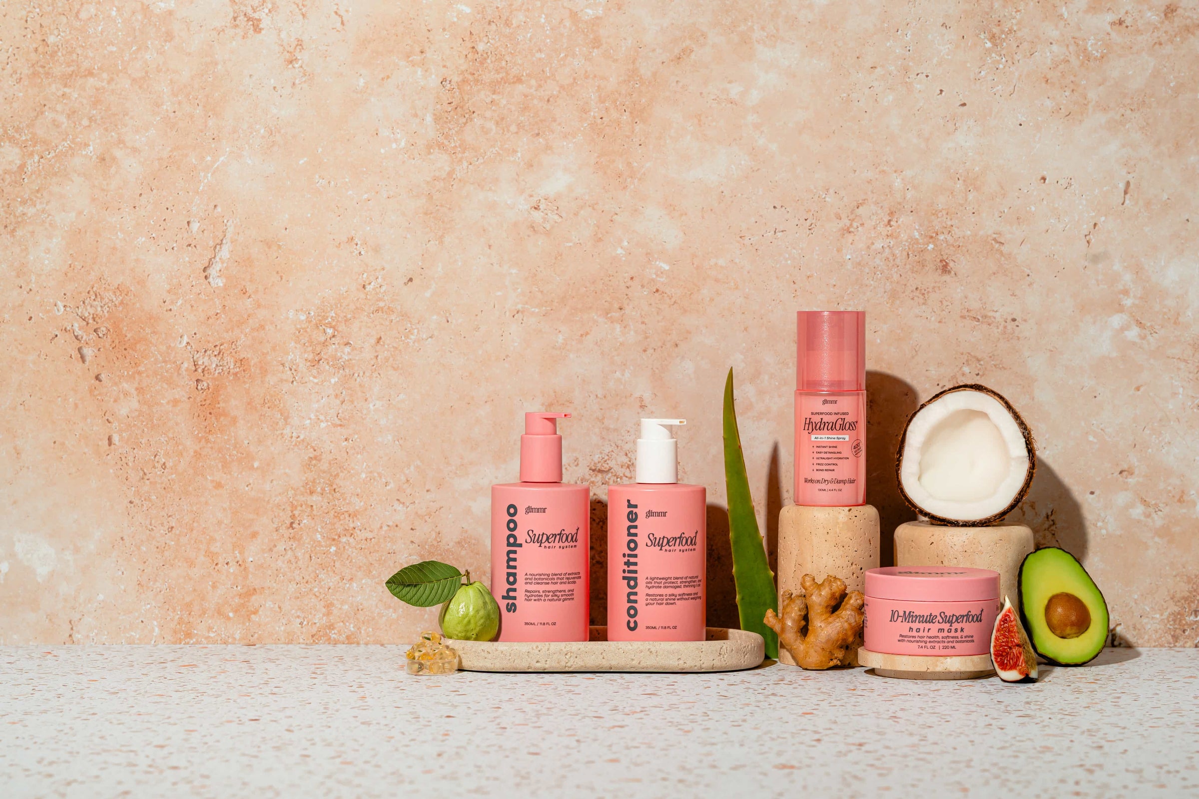 Glimmr full product line — shampoo, conditioner, shine spray, and hair mask with botanical ingredients
